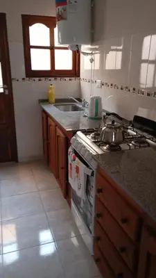 a kitchen with a stove and a sink at Dpto amueblado con cochera descubierta in Río Tercero