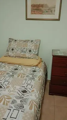 a bed in a room with a dresser and a bed sidx sidx sidx at Dpto amueblado con cochera descubierta in Río Tercero