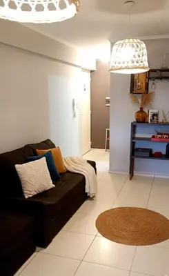 a living room with a brown couch and a rug at Rincón del Poeta - Ubicación destacada - Nueva Córdoba in Cordoba