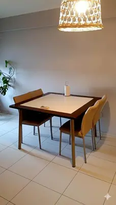 a dining room table with two chairs and a light fixture at Rincón del Poeta - Ubicación destacada - Nueva Córdoba in Cordoba