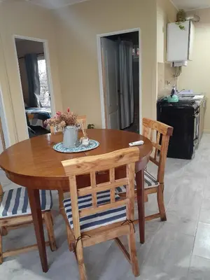 a wooden table and two chairs in a kitchen at El Alto in Yacanto