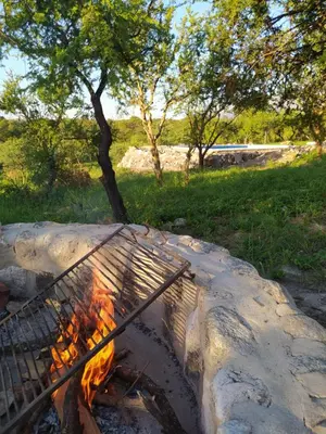 a grill with a fire in a rock at El Alto in Yacanto