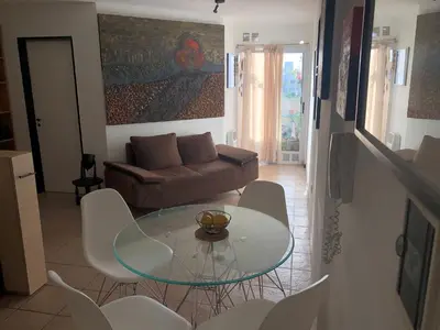 a living room with a glass table and a couch at Apartamento al 5' del Centro in Cordoba