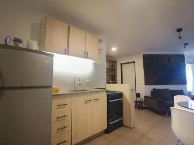 a kitchen with a refrigerator and a stove top oven at Apartamento al 5' del Centro in Cordoba