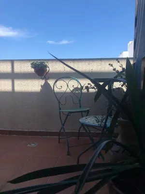 a chair sitting on a balcony with a plant at Apartamento al 5' del Centro in Cordoba
