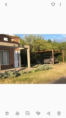 a house with a car parked in front of it at Cabaña RUSTICA exclusiva para 6 personas toda equipada in Carpintería