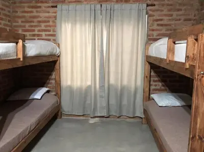 a room with two bunk beds and a window at Cabaña RUSTICA exclusiva para 6 personas toda equipada in Carpintería