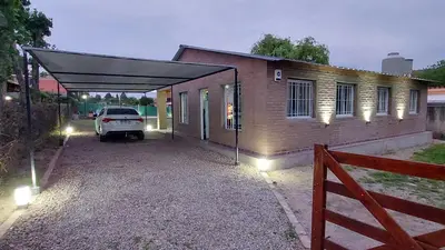 a garage with a car parked in front of a house at La soñada in San Antonio de Arredondo