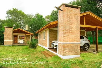 a house with a car parked outside of it at Cabañas El Cardón in Santa Rosa de Calamuchita