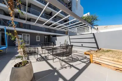 a patio with chairs and tables on a building at Viaggiato Jacinto Rios in Cordoba