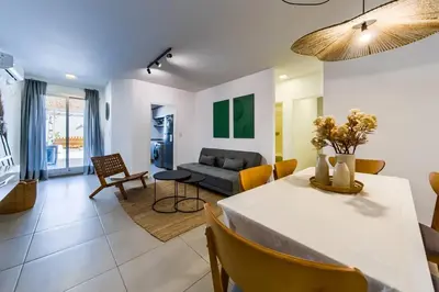 a living room with a table and a couch at Viaggiato Jacinto Rios in Cordoba