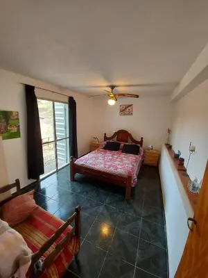a bedroom with a bed and a window at Hermosa casa con pileta en estancia vieja carlos paz in Estancia Vieja