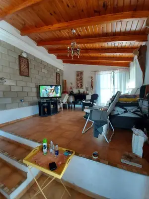 a large living room with a couch and a tv at Hermosa casa con pileta en estancia vieja carlos paz in Estancia Vieja