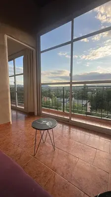 a room with a table in front of a large window at Montecielo in San Antonio de Arredondo