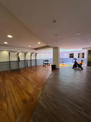 an empty room with a wooden floor and a room with motorcycles in it at Departamento amoblado con Amenities 104 INVERHOME INMOBILIARIA in Cordoba