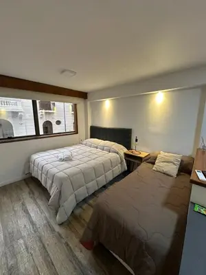 a hotel room with two beds and a window at Departamento amoblado con Amenities 104 INVERHOME INMOBILIARIA in Cordoba
