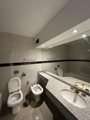a bathroom with two sinks and a toilet and a mirror at Departamento amoblado con amenities 106 INVERHOME INMOBILIARIA in Cordoba