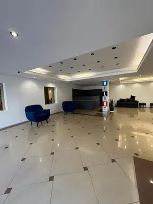 an empty lobby with blue chairs and a waiting room at Departamento amoblado con amenities 106 INVERHOME INMOBILIARIA in Cordoba