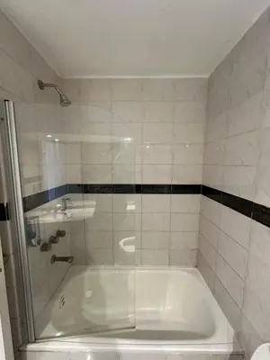 a white tub in a bathroom with a shower at Departamento amoblado con amenities 106 INVERHOME INMOBILIARIA in Cordoba