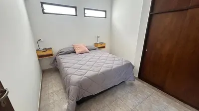 a small bedroom with a bed and a window at 760 C Apartamentos in Alta Gracia