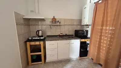 a small kitchen with a sink and a microwave at 760 C Apartamentos in Alta Gracia