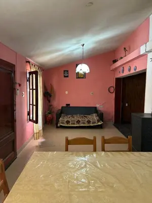 a room with a bed and a table and chairs at La Colina - Cosquín in Cosquín