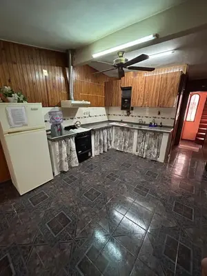 an empty kitchen with a refrigerator and a stove at La Colina - Cosquín in Cosquín