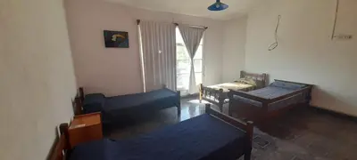 a living room with two beds and a window at La Colina - Cosquín in Cosquín
