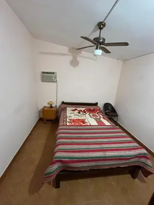a bedroom with a bed and a ceiling fan at La Colina - Cosquín in Cosquín