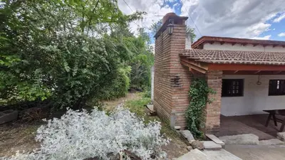 a brick building with a table in front of it at Lucía Haus in Villa General Belgrano