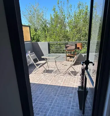 a view of a patio with a table and a grill at Miralejos 17 in Villa Carlos Paz
