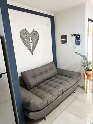 a couch in a room with a heart on the wall at Miralejos 17 in Villa Carlos Paz