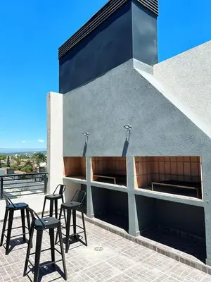 a group of chairs and tables on a building at Miralejos 17 in Villa Carlos Paz