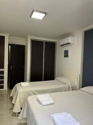 a hospital room with two beds with towels on them at Miralejos 17 in Villa Carlos Paz