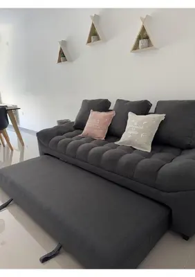 a black couch with pillows on it in a living room at Departamento Moderno Céntrico in Villa Carlos Paz