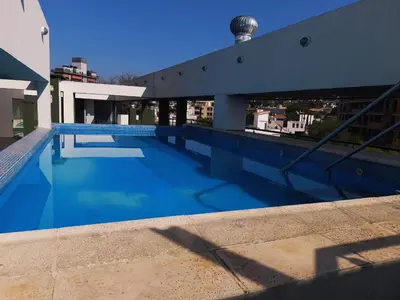 a swimming pool on the roof of a building at Dpto Tempo Carlos Paz in Villa Carlos Paz