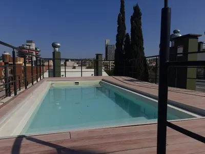 a swimming pool on the roof of a building at Dpto Tempo Carlos Paz in Villa Carlos Paz