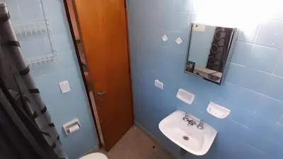 a blue bathroom with a sink and a mirror at Chalet Doña Ines in Cuesta Blanca