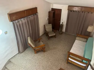 a room with a bed and two chairs and a couch at Chalet Doña Ines in Cuesta Blanca