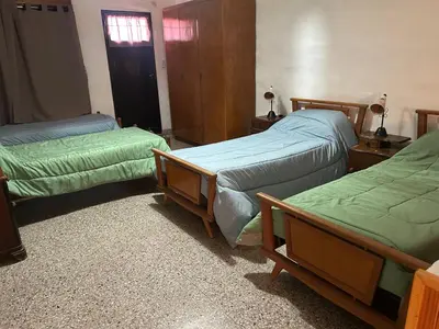 a room with three beds and a window at Chalet Doña Ines in Cuesta Blanca