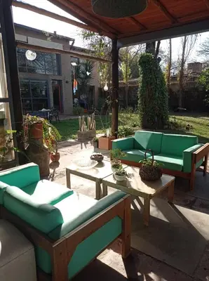 a patio with couches and tables in a yard at Casa Los Algarrobos in Cordoba