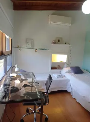 a room with a glass table and a bed at Casa Los Algarrobos in Cordoba