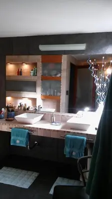 a bathroom with two sinks and two mirrors at Casa Los Algarrobos in Cordoba