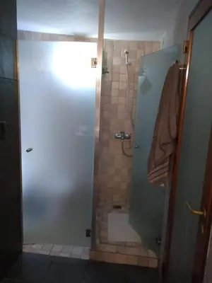 a bathroom with a shower with a glass door at Casa Los Algarrobos in Cordoba