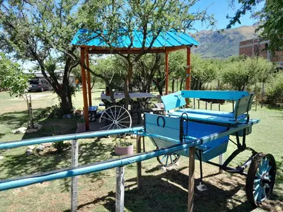 a blue horse drawn carriage in a park at Cabaña los Lechusos in Cortaderas