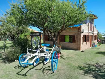 a blue and white bike parked in front of a sign at Cabaña los Lechusos in Cortaderas