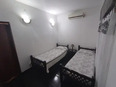 two beds in a room with lights on the wall at Casa Tupungato in Villa Carlos Paz