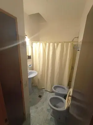 a bathroom with two toilets and a sink at Casa Tupungato in Villa Carlos Paz
