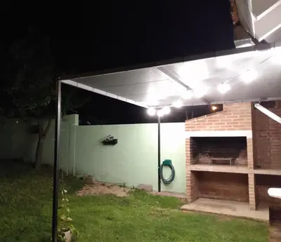 awning over a patio at night with a fireplace at Casa Yowen in Mina Clavero