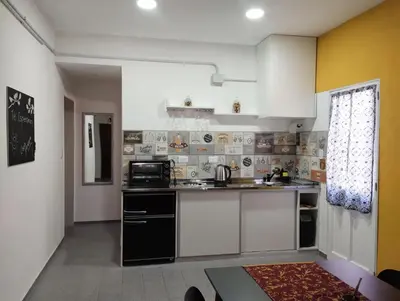 a kitchen with white cabinets and a counter top at Casa Yowen in Mina Clavero